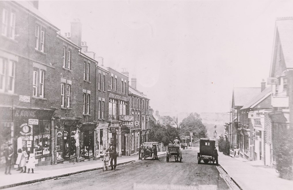 Early car parked on London Road, opposite a motor garage