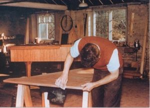 John working on the case of harpsichord F2 in 1958, © Emily Feldberg