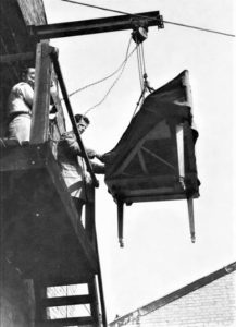 Lowering a harpsichord from the workshop