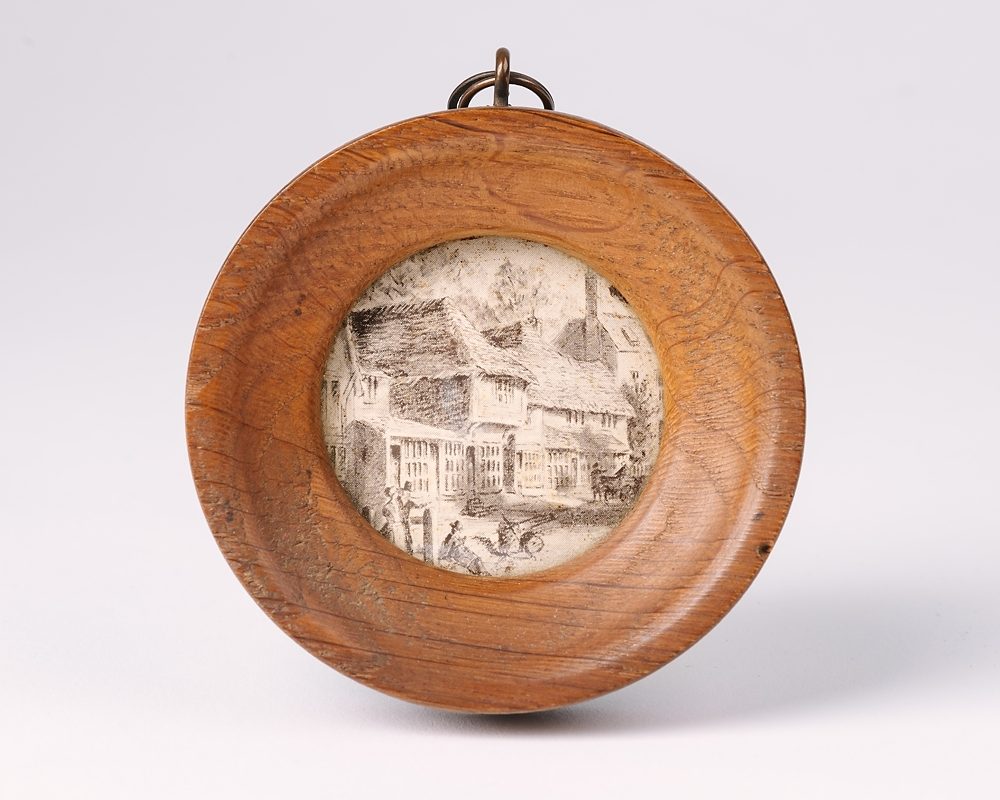 Small round wooden picture frame with illustration inside
