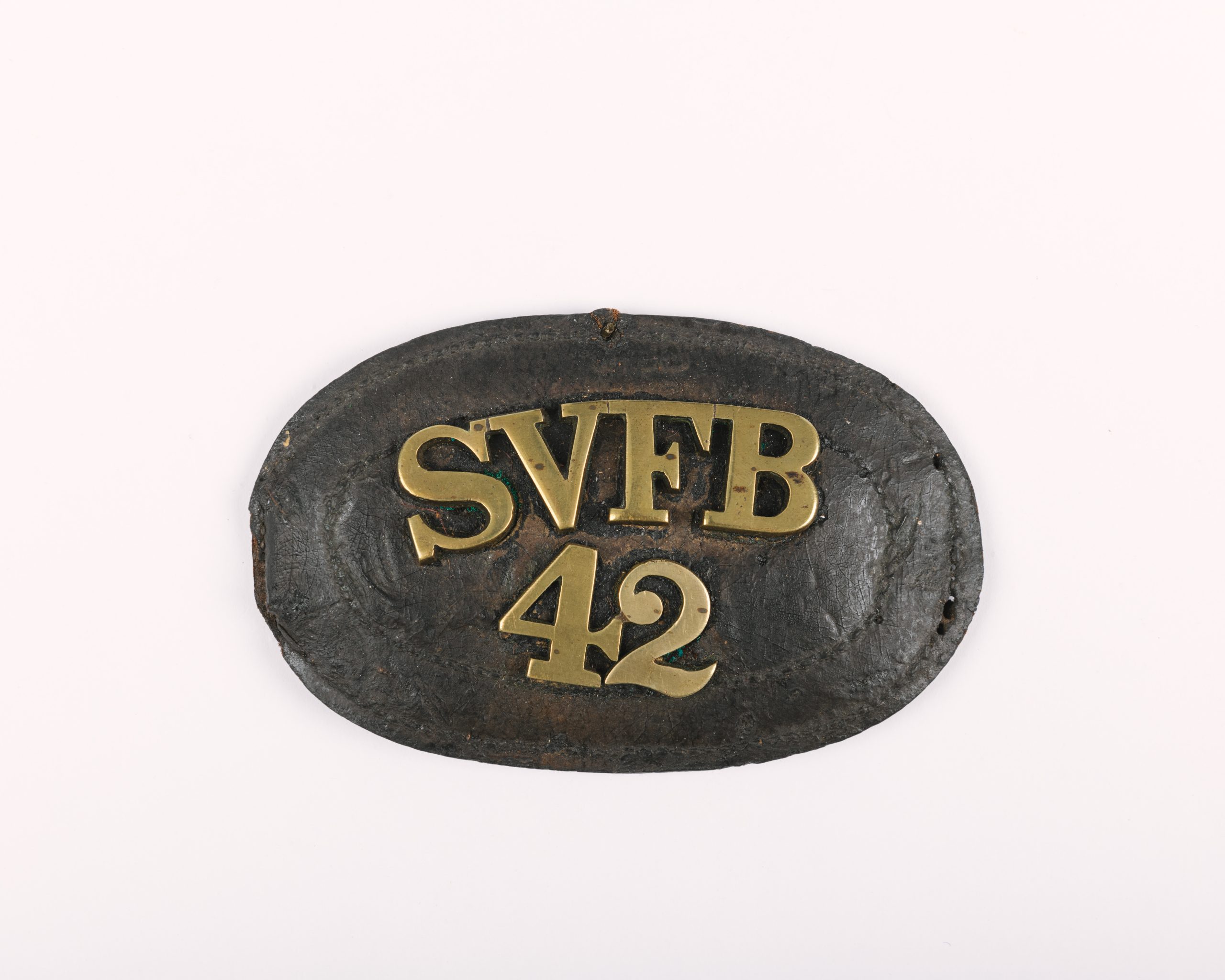 Oval badge with Gold lettering. Inscription reads SVFB 42
