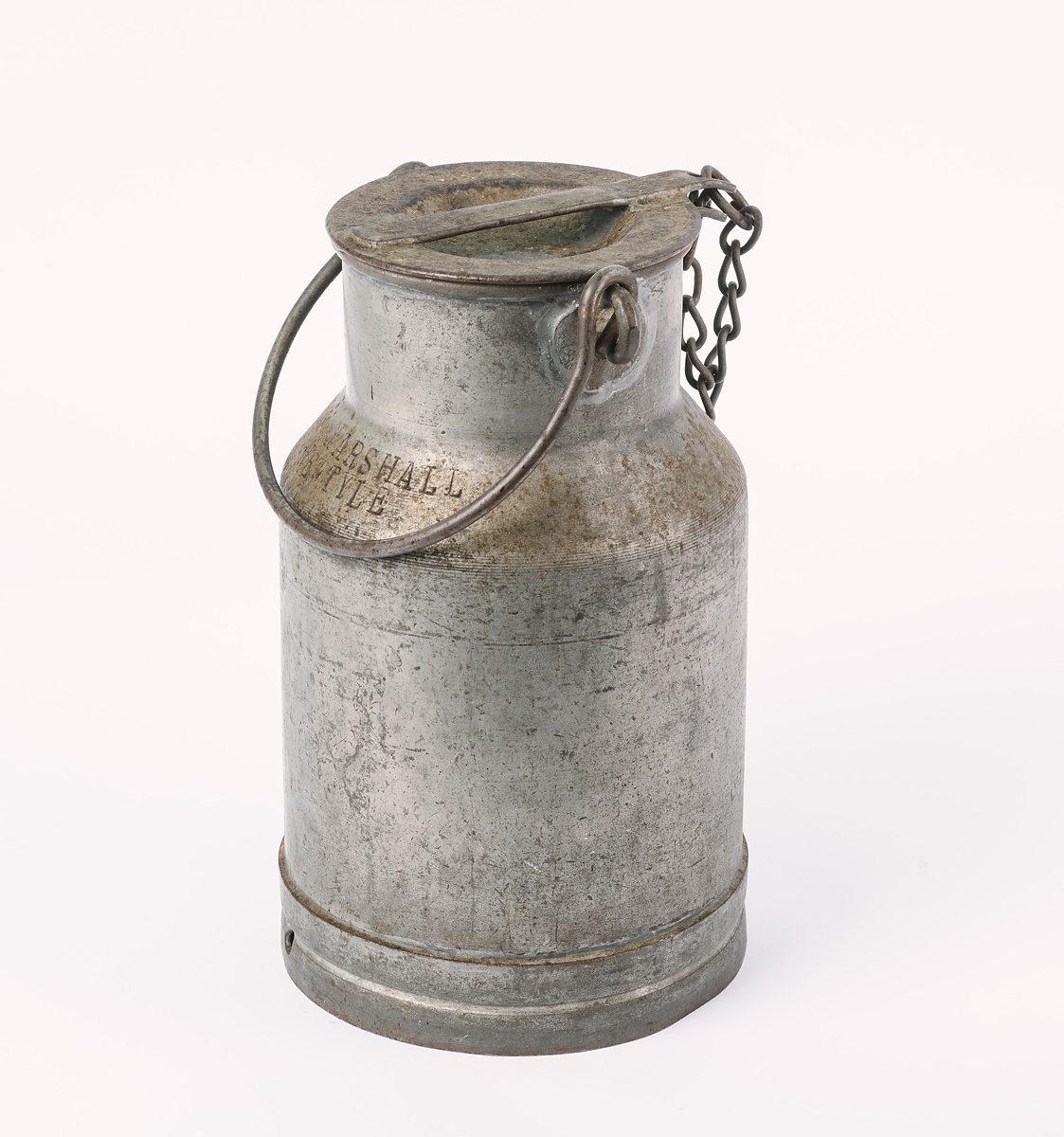 Metal milk churn with carrying handle and screw-off top on chain